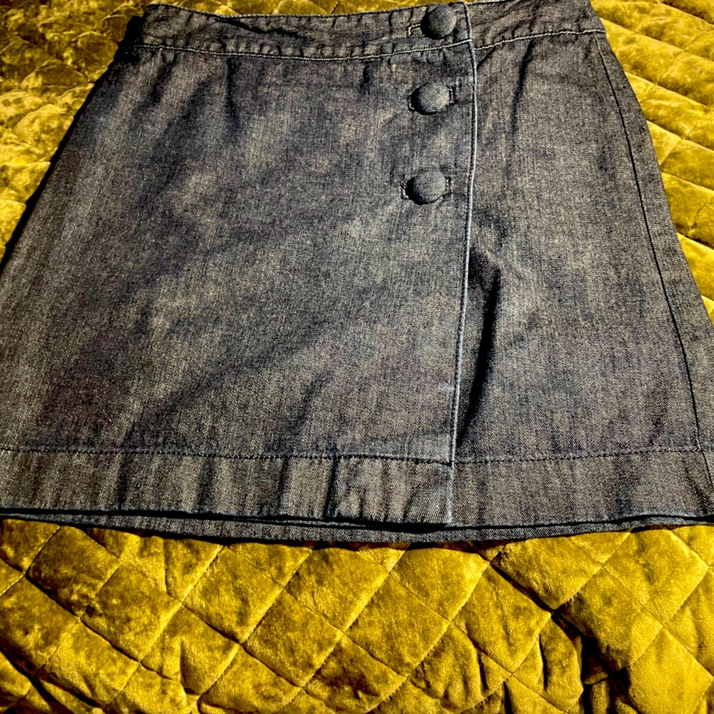 Cute denim wrap skirt with three matching denim covered buttons.